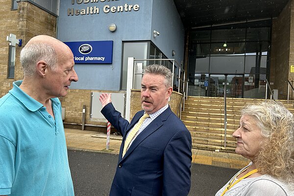 Picture of Donal speaking to people outside of Todmorden Health Centre